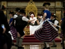 Children dressed in traditional Bavarian costumes dance for the Pope during his 85th birthday celebrations in the Clementine Hall. 