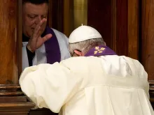 Pope Francis receives absolution during a penitential celebration at St. Peter's Basilica, March 28, 2014. 