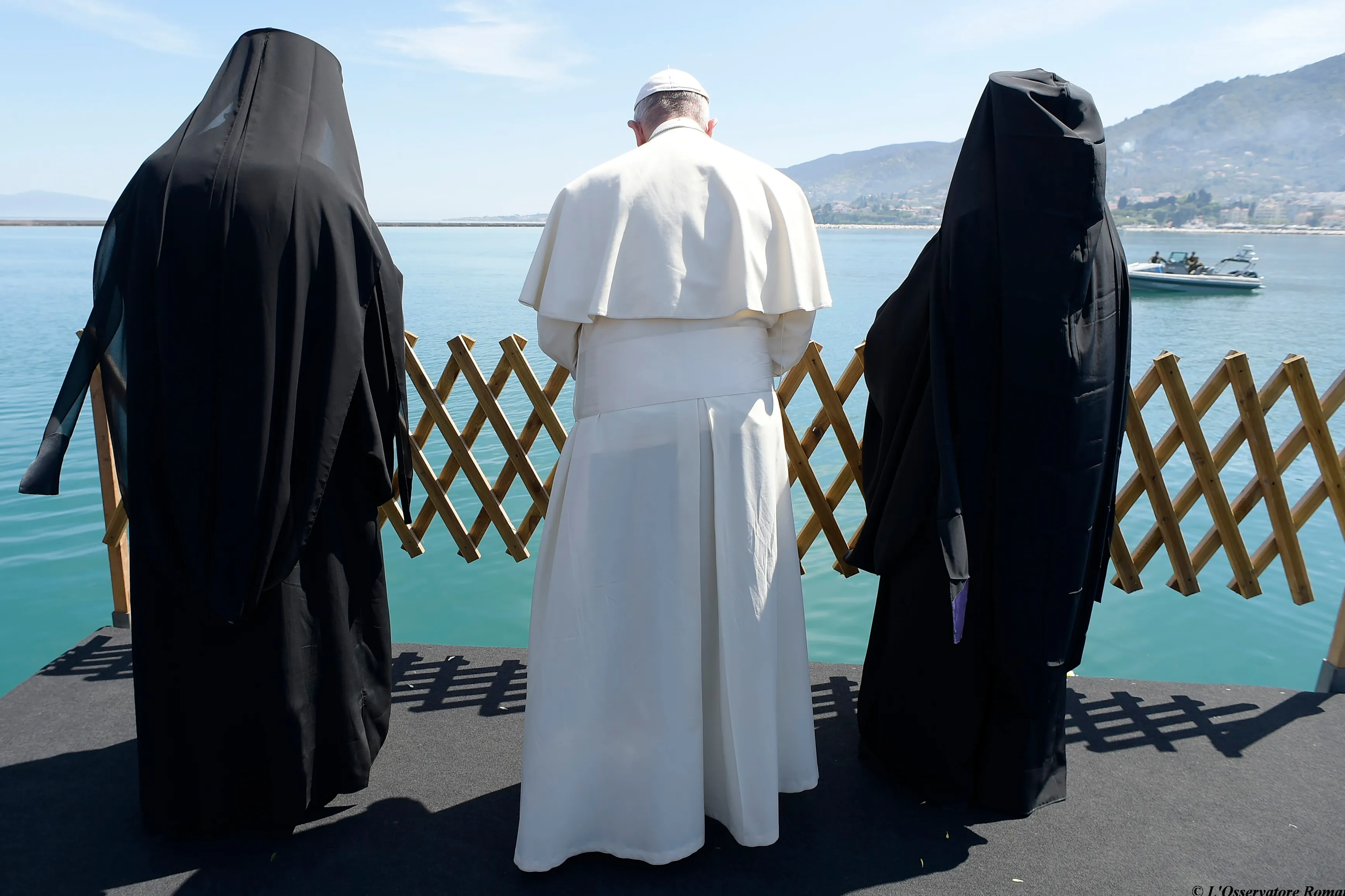 Pope Francis, Patriarch Bartholomew and Archbishop Ieronymos look out at the sea from Lesbos Apri. 16. ?w=200&h=150