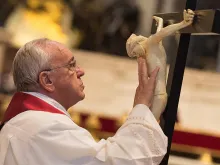 Pope Francis and the cross at the Liturgy of the Lord's Passion at St. Peter's Basilica on April 3, 2015. 