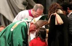 Pope Francis leans down to a girl at Feb. 23 Sunday Mass at St. Peter's Basilica, ?w=200&h=150