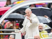 Pope Francis waves at a rainy general audience April 10, 2019. 