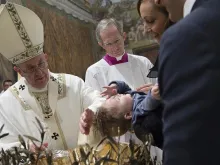 Pope Francis baptizes a baby in the Sistine Chapel Jan. 10, 2016. 
