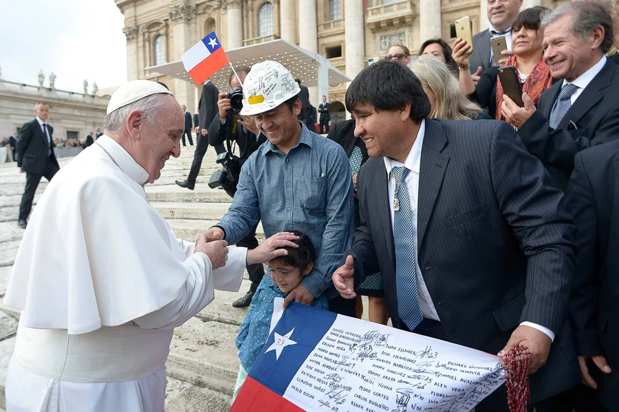 Pope Francis blesses Esperanza Ticona with her father, miner Ariel Ticona, and Esteban Rojas in St. Peter's Square, Oct. 14, 2015. ?w=200&h=150