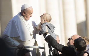 Pope Francis blesses a baby Nov. 21, 2018.   MarinaTestino/CNA.