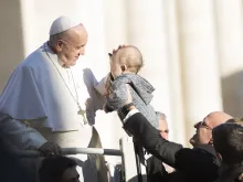 Pope Francis blesses a baby Nov. 21, 2018. 