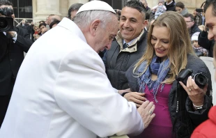 Pope Francis blesses a woman and her unborn child at a Jubilee Audience in St. Peter's Square, Jan. 30, 2016.   L'Osservatore Romano.