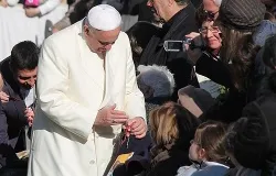 Pope Francis blesses a rosary for a pilgrim in St. Peter's Square during the Wednesday general audience on Dec. 4, 2013 ?w=200&h=150