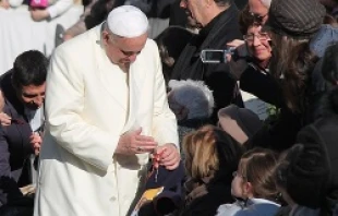 Pope Francis blesses a rosary for a pilgrim in St. Peter's Square during the Wednesday general audience on Dec. 4, 2013   Kyle Burkhart/CNA