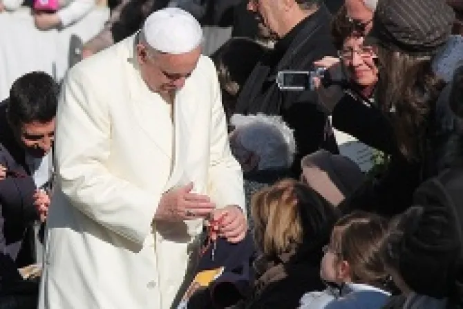 Pope Francis blesses a rosary for a pilgrim in St Peters Square during the Wednesday general audience on Dec 4 2013 Credit Kyle Burkhart CNA CNA 12 4 13
