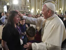 Pope Francis blesses a woman after venerating the relics of Peruvian saints in the Cathedral of Lima, Jan. 21.  