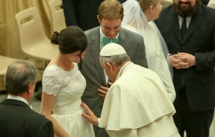 Pope Francis blesses the baby in the womb of a newly married couple at the Wednesday general audience in Paul VI Hall, Feb. 4, 2015.   Daniel Ibáñez/CNA.