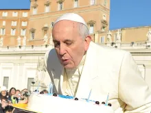 Pope Francis blows out candles on a cake for his 78th birthday in St. Peter's Square during his Wednesday general audience on Dec. 17, 2014. 