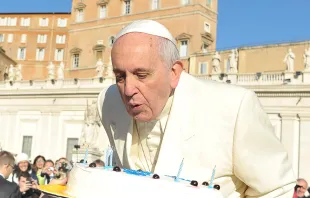 Pope Francis blows out candles on a cake for his 78th birthday in St. Peter's Square during his Wednesday general audience on Dec. 17, 2014.   ANSA / L'OSSERVATORE ROMANO