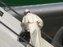 Pope Francis boards the papal plane carrying his black bag at Rome's Fiumicino Airport on July 22, 2013. ANSA/TELENEWS.
