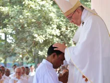Pope Francis lays hands on a Bangladeshi deacon as he ordains him to the priesthood during a Dec. 1, 2017 Mass in Dhaka. 