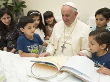 Pope Francis eats lunch with 21 Syrian refugees in the Casa Santa Marta Aug. 11, 2016. 