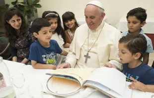 Pope Francis eats lunch with 21 Syrian refugees in the Casa Santa Marta Aug. 11, 2016.   L'Osservatore Romano.