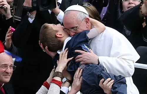 Pope Francis embraces a boy prior to his first 'Urbi et Orbi' blessing on Easter Sunday, March 31, 2013. ?w=200&h=150