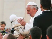 Pope Francis embraces a child at the general audience in St. Peter's Square, Dec. 16, 2015. 