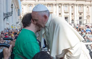 Pope Francis embraces a man in a wheelchair at the Wednesday general audience in St. Peter's Square on June 10, 2015.   L'Osservatore Romano.
