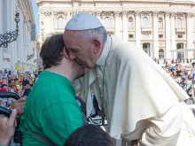 Pope Francis embraces a man in a wheelchair at the Wednesday general audience in St. Peter's Square on June 10, 2015.