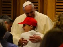 Pope Francis embraces a young student on May 31, 2014 in Paul VI audience hall. 