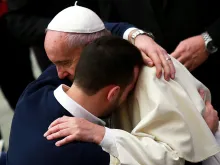 Pope Francis embraces a pilgrim during the General Audience at the Vatican's Paul VI Hall, Jan. 13, 2016. 