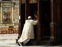 Pope Francis goes to Confession during a penitential celebration at St. Peter's Basilica, March 28, 2014. 