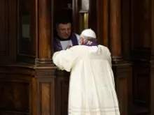 Pope Francis receives the sacrament of Confession at the penance service held at St. Peter's Basilica, March 28, 2014. 