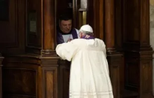 Pope Francis receives the sacrament of Confession at the penance service held at St. Peter's Basilica, March 28, 2014.   ANSA/OSSERVATORE ROMANO.