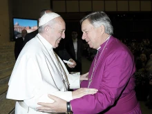 Pope Francis greets David Moxon, the Archbishop of Canterbury's representative to the Holy See, at the Vatican, Jan. 25, 2017. 