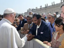 Pope Francis greets Ashiq Mesih in St. Peter's Square during the Wednesday general audience on April 15, 2015. 