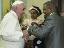 Pope Francis greets a family at Our Lady of the Assumption Cathedral, Santiago de Cuba, Sept. 22, 2015. 
