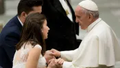 Pope Francis greets a married couple at a Wednesday General Audience.