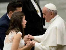 Pope Francis greets a married couple at a Wednesday General Audience. 