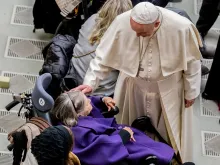 Pope Francis greets a woman before the general audience Dec. 19, 2018. 