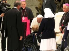 Pope Francis greets an elderly woman in a wheelchair Nov. 23, 2013. 