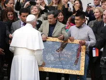 Pope Francis is presented with the signatures of the 33 miners who were rescued in 2010 from Copiapó mine, at the General Audience in St. Peter's Square, Oct. 14, 2015. 