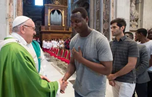 Pope Francis greets migrants July 6, 2018 after Mass for the anniversary of his visit to Lampedusa.   Vatican Media.