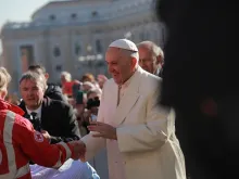 Pope Francis greets pilgrims during his Nov. 16, 2016, general audience. 