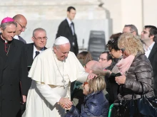 Pope Francis greets pilgrims in St. Peter's Square, Dec. 17, 2014. 