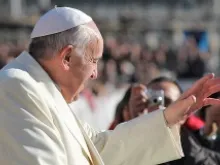 Pope Francis greets pilgrims in St. Peter's Square before the Wednesday general audience Dec. 4, 2013. 
