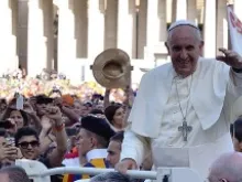 Pope Francis greets pilgrims in St. Peter's Square for the Italian Sporting Center's celebration of sports June 7, 2014. 