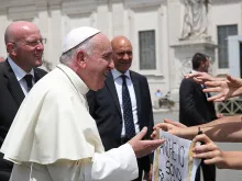 Pope Francis greets pilgrims in St. Peter's Square for the Wednesday general audience on June 17, 2015. 