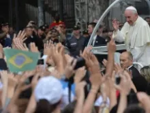 Pope Francis greets the faithful as he arrives on the popemobile at the San Joaquin Episcopal Palace in Rio de Janeiro on July 26, 2013. ANSA/Luca Zennaro/Pool.
