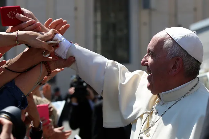 Pope Francis hands rosaries to pilgrims in St. Peter's Square during his general audience May 4, 2016. ?w=200&h=150