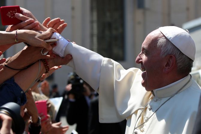 Pope Francis hands rosaries to pilgrims in St Peters Square during his general audience May 4 2016 Credit Daniel Ibez CNA