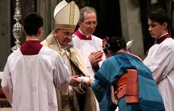 Pope Francis gives a book of the Gospels to a catechumen Nov. 23, 2013. ?w=200&h=150