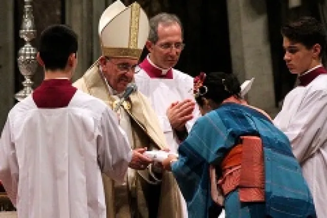 Pope Francis hands the book of the Gospels to a catechumen during Mass on Nov 23 2013 Credit Lauren Cater CNA CNA 11 24 13